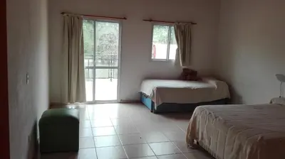 a bedroom with two beds and a window at Nuestro Rinconcito in Villa Cura Brochero