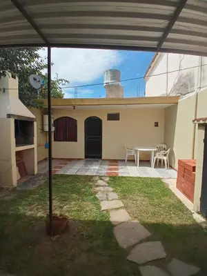 a patio with a table and chairs in front of a house at Nuestro Rinconcito in Villa Cura Brochero