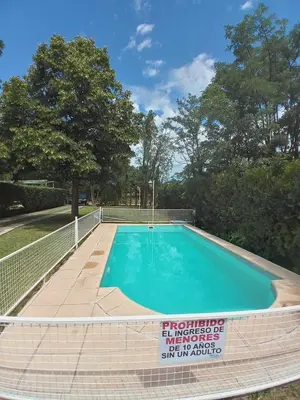 a swimming pool with a fence around it at Nuestro Rinconcito in Villa Cura Brochero