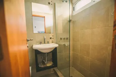 a bathroom with a sink and a shower at lacasonavistalago in Villa Carlos Paz