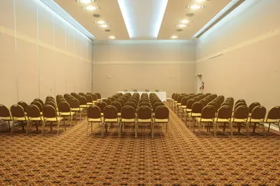 a room with chairs and a table in it at Howard Johnson Rio Cuarto Hotel y Casino in Río Cuarto