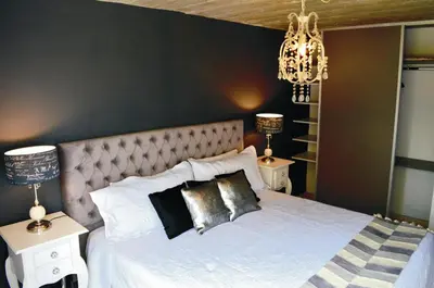a bedroom with a white bed with two night stands at Lago Manso in Potrero de Garay