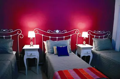 a bedroom with two beds and two tables with lamps at Lago Manso in Potrero de Garay