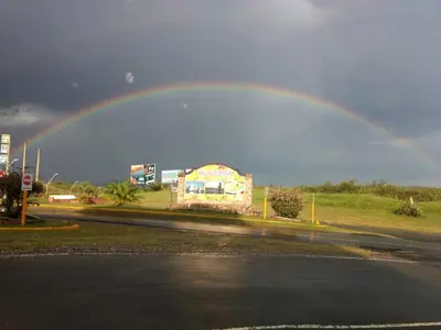a rainbow in the sky over a street at 2 PAX Departamentos in Villa Rumipal