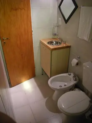 a bathroom with a toilet and a sink at 2 PAX Departamentos in Villa Rumipal