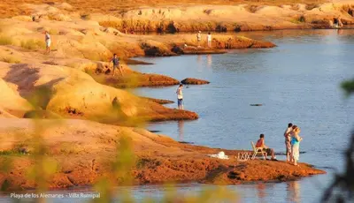 a group of people standing on rocks near a river at 2 PAX Departamentos in Villa Rumipal