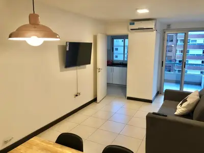 a living room with a couch and a table at Departamentos Mediterraneo in Cordoba