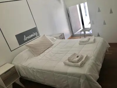a bedroom with a bed with towels on it at Departamentos Mediterraneo in Cordoba