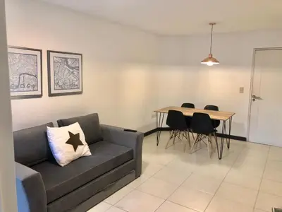 a living room with a couch and a table at Departamentos Mediterraneo in Cordoba