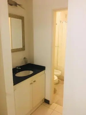 a bathroom with a sink and a mirror and a toilet at Departamentos Mediterraneo in Cordoba