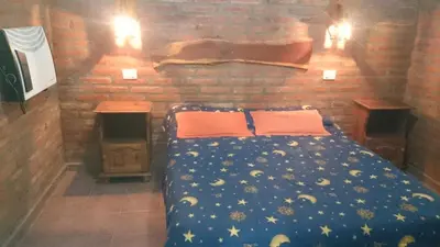 a bedroom with a blue bed with stars on it at Cabañas Simpson in Santa Rosa de Calamuchita