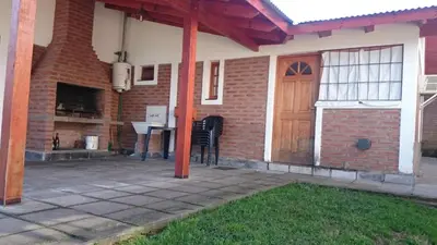 a house with a patio with a wooden door at Cabañas Simpson in Santa Rosa de Calamuchita
