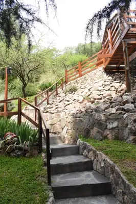 a set of stone stairs with a wooden fence at El Chañar in Villa General Belgrano