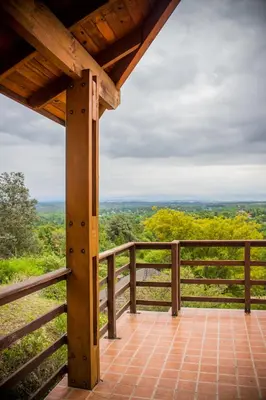 a view from the porch of a cabin with a wooden fence at Cabañas Mirasoles in Villa General Belgrano