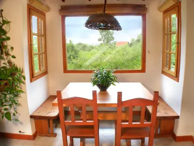 a dining room with a table and a window at Cabañas Mirasoles in Villa General Belgrano