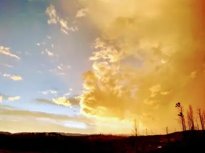 a cloudy sky with the sun setting in the distance at Serranias Del Tabaquillo in San Miguel de los Rios