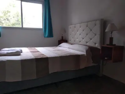 a bedroom with a large bed with a window at Campo de los Zorros in Nono