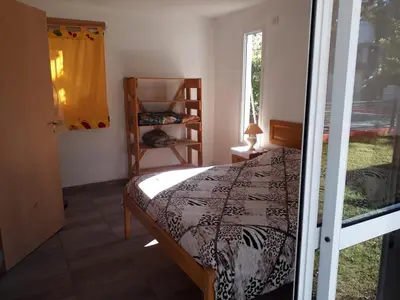 a bedroom with a bed and a window at Complejo Leon in Villa Rumipal