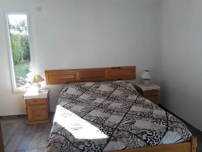 a bedroom with a bed and a large window at Complejo Leon in Villa Rumipal