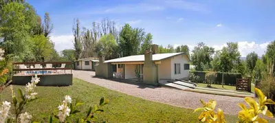 a small house in a yard with a pool at Cabañas Dolce Vita II in Los Reartes