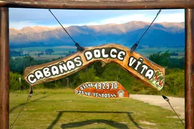a sign that reads emergency police unit with mountains in the background at Cabañas Dolce Vita I in Los Reartes