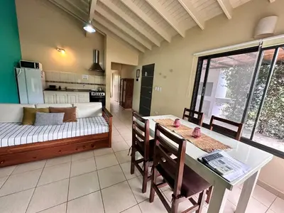 a living room with a couch and a table at Villa Bonita Cabañas Villa de Merlo in Merlo