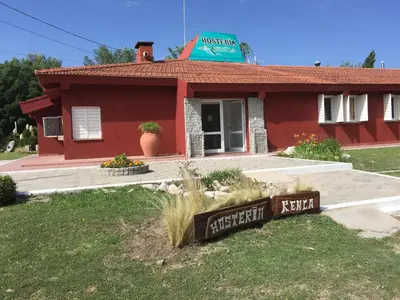 a red house with a sign in front of it at Hosteria Renca in Renca