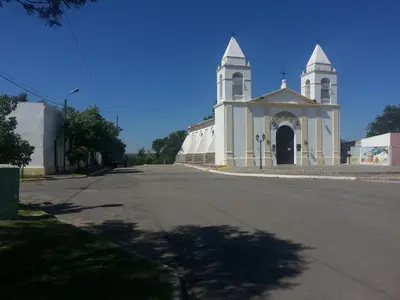 a large white church with a steeple on a street at Hosteria Renca in Renca