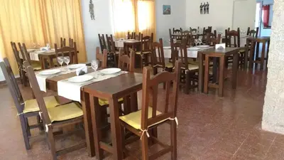 a dining room with wooden tables and chairs at Hosteria Renca in Renca