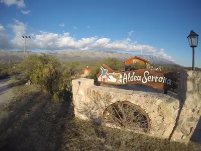 a sign for a village center on a stone wall at Aldea Serrana in Nono