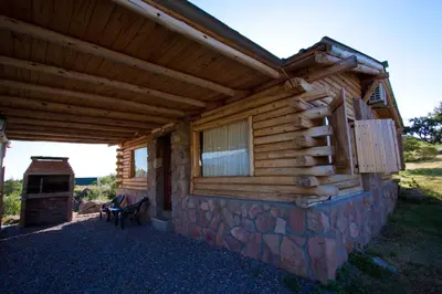 a log cabin with a porch and a window at Aldea Serrana in Nono
