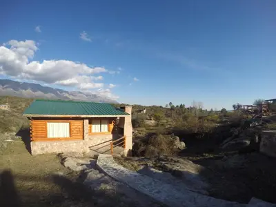 a small wooden house with a green roof at Aldea Serrana in Nono