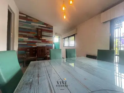 a conference room with a large wooden table and chairs at ViviSierras, Carlos Paz casa centro frente al lago, pileta climatizada, 4 dormitorios, 3 baños, quincho in Villa Carlos Paz