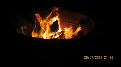 a fire burns inside of a fire oven at Cabañas Entre Verde in Los Hornillos