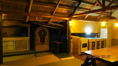 a room with a kitchen and a table in a house at Cabañas Entre Verde in Los Hornillos