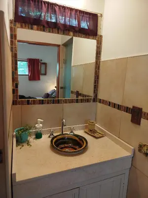 a bathroom with a sink and a mirror at Cabañas Entre Verde in Los Hornillos