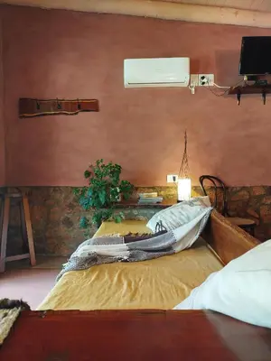 a bedroom with a large bed in a room at Cabañas Entre Verde in Los Hornillos