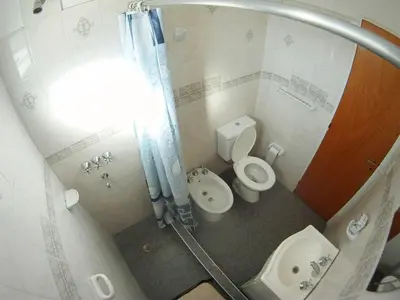 a small bathroom with a toilet and a sink at Casa en Balneario Sol y Rio in Villa Carlos Paz