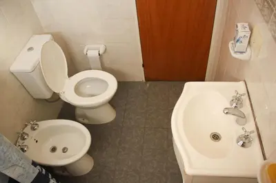a bathroom with a toilet and a sink at Casa en Balneario Sol y Rio in Villa Carlos Paz