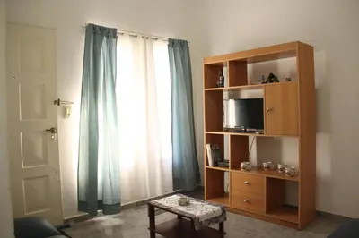 a living room with a book shelf and a window at Casa en Balneario Sol y Rio in Villa Carlos Paz