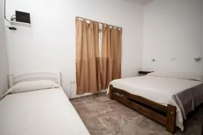 a bedroom with two beds and a window at Casa en Balneario Sol y Rio in Villa Carlos Paz