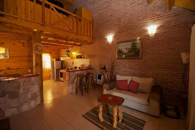 a living room with a couch and a brick wall at Rancho Paradise - Adults Only in Nono