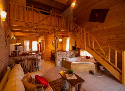 a living room with a staircase and a bath tub at Rancho Paradise - Adults Only in Nono