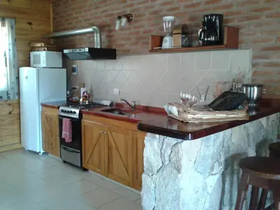 a kitchen with a counter with a sink and a refrigerator at Rancho Paradise - Adults Only in Nono