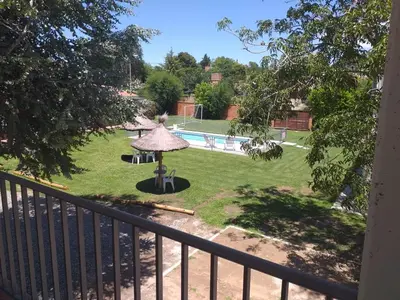 a view from a balcony of a yard with a pool at Abuela Mari Apart Cabaña in Villa Cura Brochero