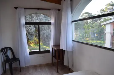 a bedroom with a window with a desk and a chair at Estancia Santa Leocadia in Bialet Massé