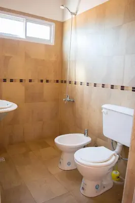 a bathroom with a toilet and a sink at Estancia Santa Leocadia in Bialet Massé