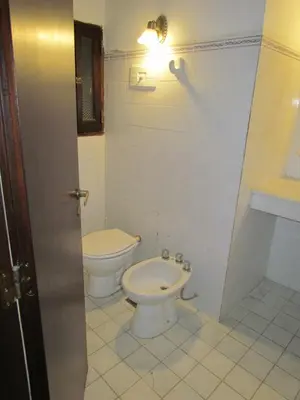 a bathroom with a toilet and a sink at La Posada de Akasha in Villa General Belgrano