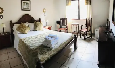 a bedroom with a bed with towels on it at La Posada de Akasha in Villa General Belgrano