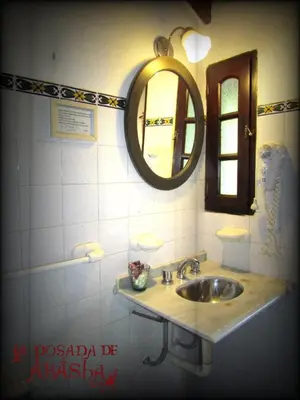 a bathroom with a sink and a mirror at La Posada de Akasha in Villa General Belgrano